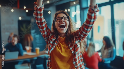 A dynamic shot of a startup founder celebrating with their team after successfully launching a product