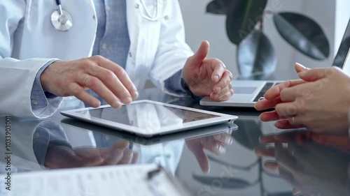 Wallpaper Mural Doctor and patient conversation with tablet computer in clinic office. Medicine and Health care Torontodigital.ca