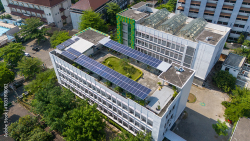 This modern building boasts solar panels and lush gardens amid city skyscrapers photo