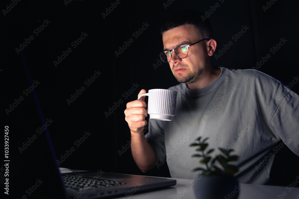 Young man works at the computer at night. Young man works at the computer at night.