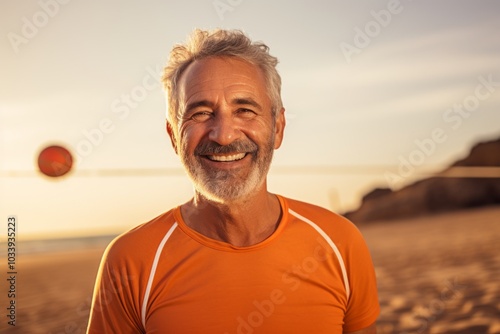 Portrait of a cheerful man in his 60s sporting a breathable mesh jersey over sandy beach background