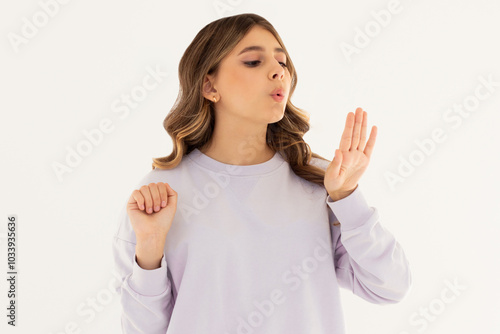 Young caucasian woman looking at manicure on white background