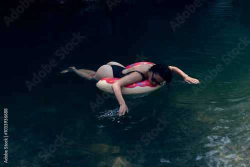 Woman Relaxing on Inflatable Float in Tranquil Natural Lagoon