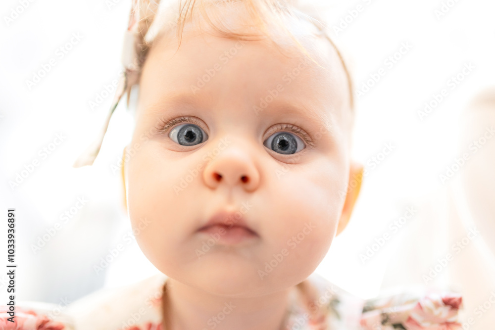 Adorable Curiosity Baby Portrait with Big Blue Eyes in Soft Light Adorable Curiosity Baby Portrait with Big Blue Eyes in Soft Light