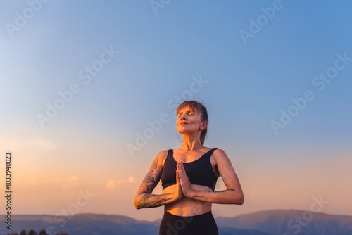 Obraz na płótnie Woman Practicing Breathing Yoga on Nature at Sunset w salonie