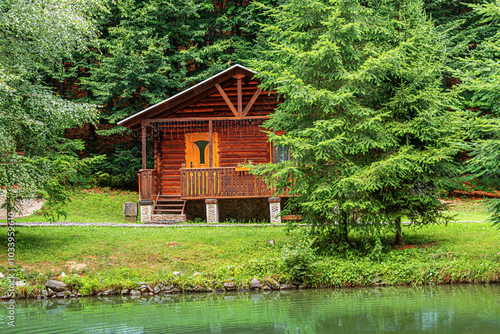 Wooden house in green forest in summer day. Wooden house in green forest in summer day.