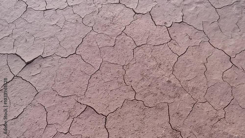 Closeup of cracked red soil texture due to hot sunlight. Handheld footage. Closeup of cracked red soil texture due to hot sunlight. Handheld footage.