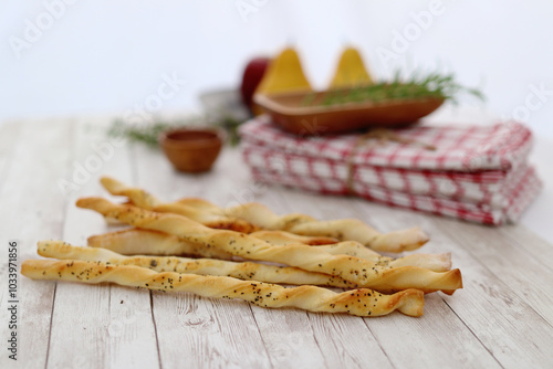 Homemade breadsticks on a rustic picnic table