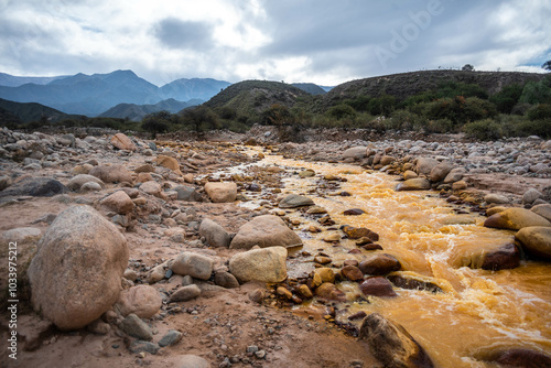 Hermosa vista del Río de Dos colores en la localidad de Chilecito, provincia de La Rioja, en Argentina, donde se puede apreciar una mezcla de colores cobrizos y grises entre rocas y montañas. photo