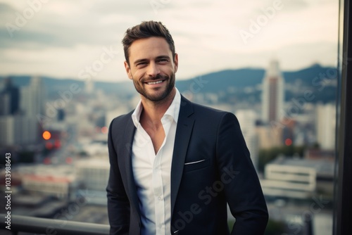 Portrait of a smiling man in his 30s dressed in a stylish blazer in front of modern cityscape background