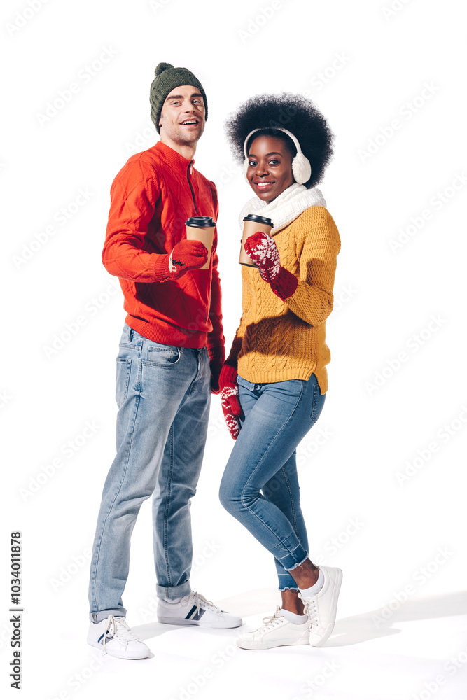 A cheerful couple celebrates the winter season with warm drinks, joyful smiles, and vibrant holiday sweaters. A cheerful couple celebrates the winter season with warm drinks, joyful smiles, and vibrant holiday sweaters.