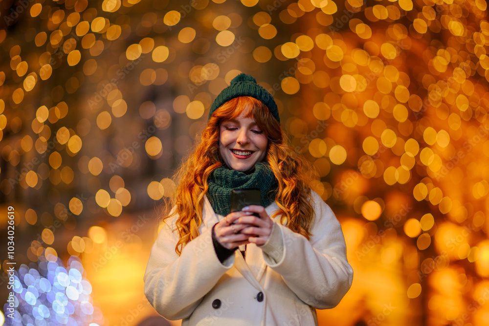 A cheerful ginger woman is texting messages on street on new year's eve. A cheerful ginger woman is texting messages on street on new year's eve.