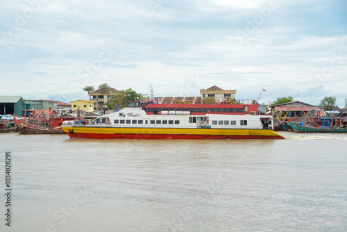 Kedah, Malaysia: October 17th, 2024- The image shows a large passenger ferry docked at a port or terminal. photo