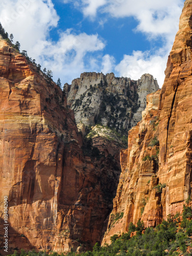 The Great White Throne, one of iconic mountain peaks in Zion National, Utah, USA, peaking out between two steep sandstone cliffs along the Canyon rim at Weeping Rock.