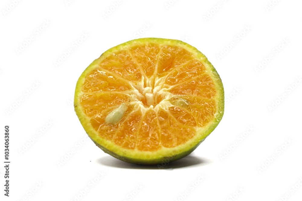 A close-up photo of a halved orange. The orange has a bright orange interior and a slightly green exterior. The photo is taken against a white background. A close-up photo of a halved orange. The orange has a bright orange interior and a slightly green exterior. The photo is taken against a white background.