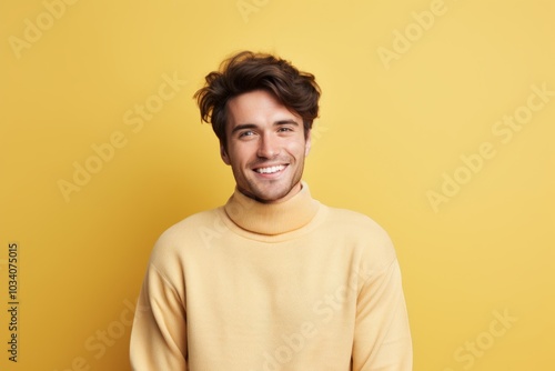 Portrait of a jovial man in his 20s wearing a classic turtleneck sweater in pastel or soft colors background