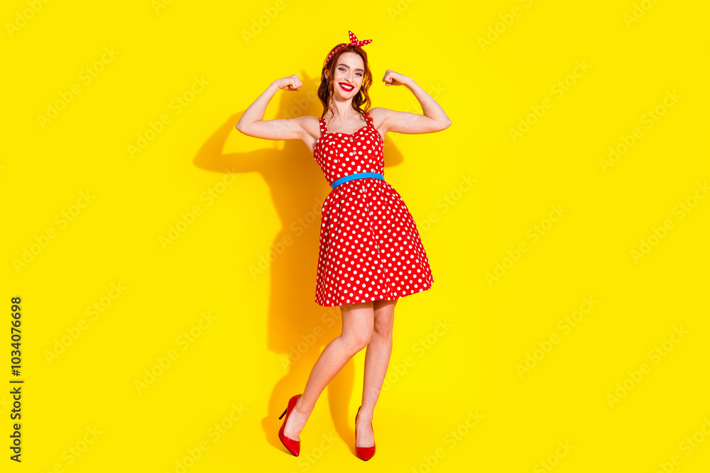 Photo of lovely cute positive strong lady wear red trendy clothes isolated on yellow color background Photo of lovely cute positive strong lady wear red trendy clothes isolated on yellow color background