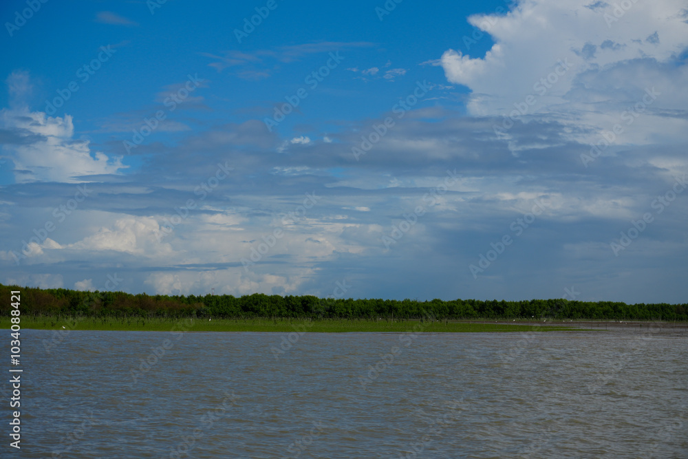 A serene summer scene of clouds reflecting over a tranquil lake and river, surrounded by lush trees and blue skies A serene summer scene of clouds reflecting over a tranquil lake and river, surrounded by lush trees and blue skies