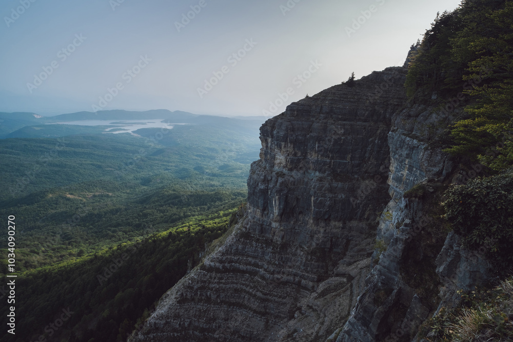 sheer cliff above a valley in the mountains, view of a mountain lake, steep cliff sheer cliff above a valley in the mountains, view of a mountain lake, steep cliff