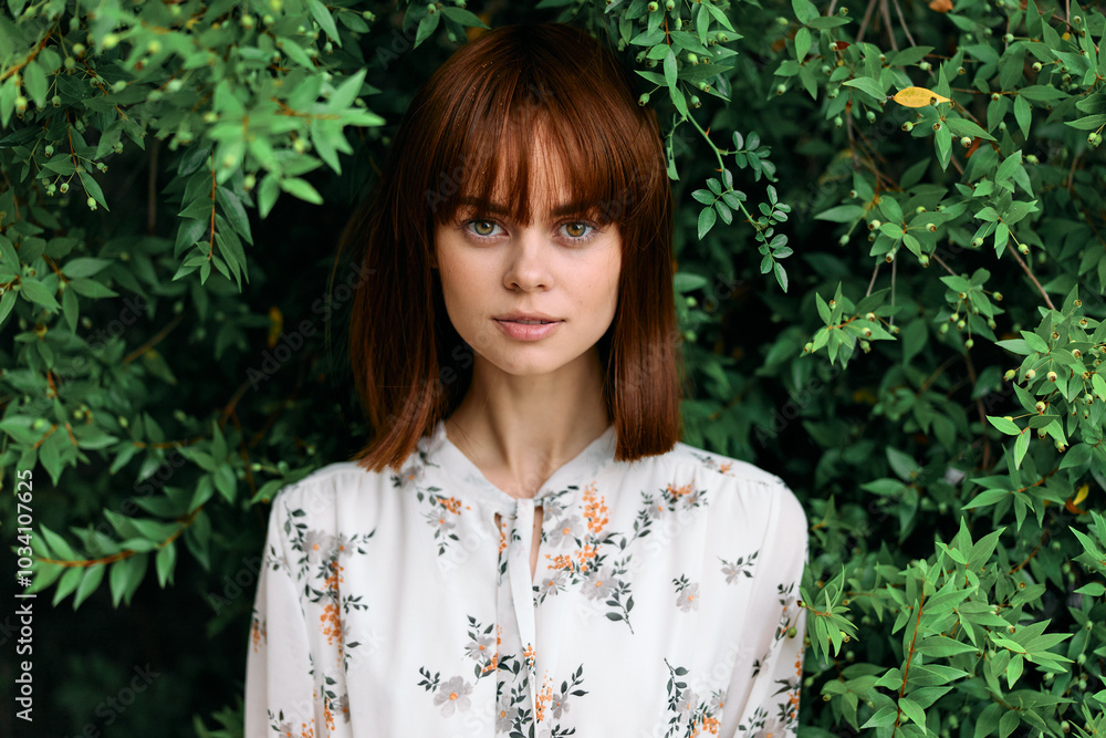 Serene redhead woman surrounded by lush greenery gazes off into the distance Serene redhead woman surrounded by lush greenery gazes off into the distance