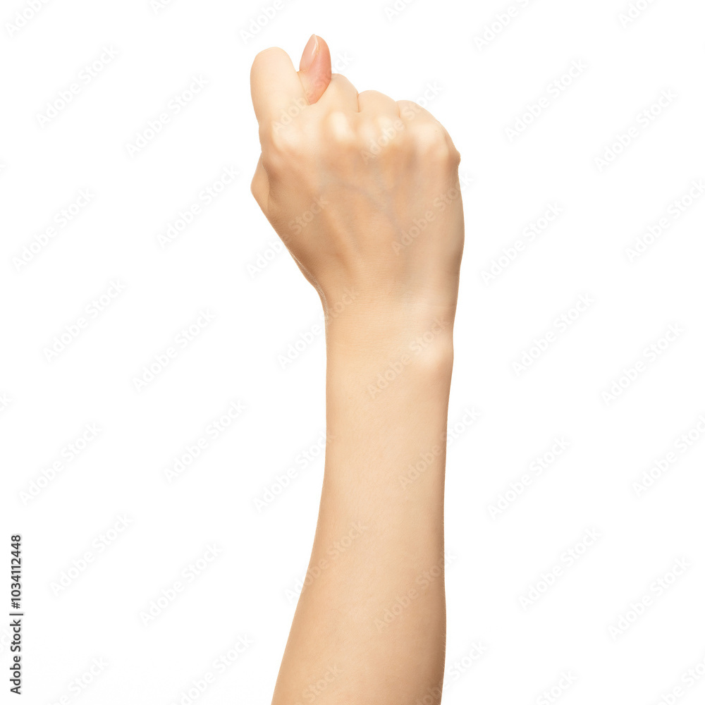 A woman's hand is shown with her fingers curled into a fist, with her thumb pointing upward. The hand is isolated against a white background A woman's hand is shown with her fingers curled into a fist, with her thumb pointing upward. The hand is isolated against a white background