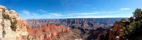 Breathtaking panoramic view of the Grand Canyon under a clear blue sky.