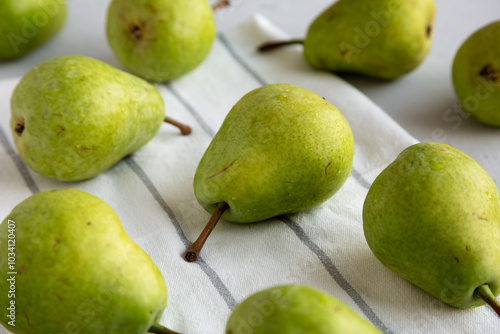 Raw Organic Lucas Pears in a Bunch, side view.