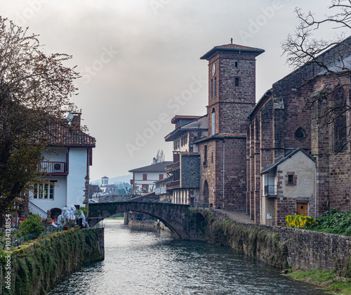 Photo of the Nive river and the church in the town of Saint Jean Pied de Port in the French Basque country. photo