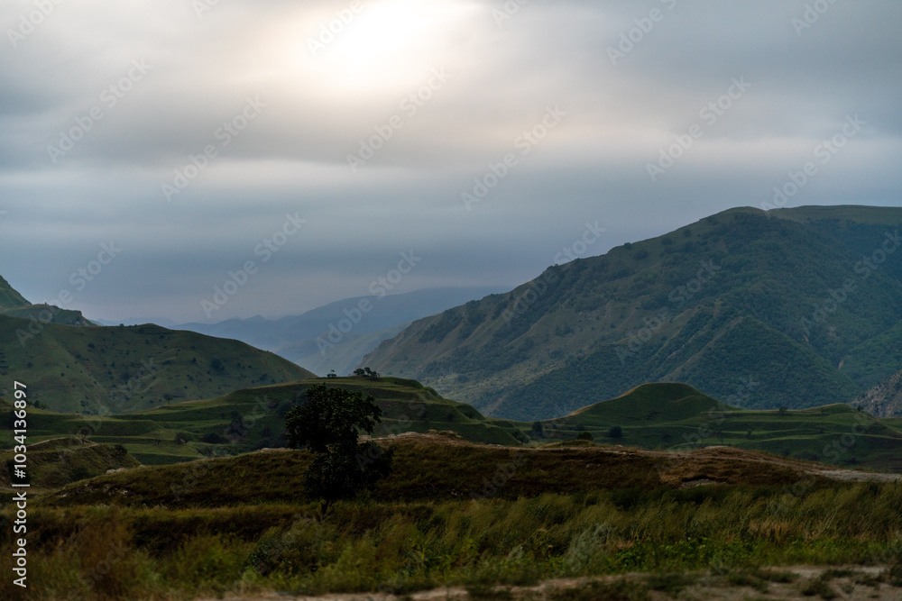 Fototapeta premium A mountain range with a cloudy sky in the background