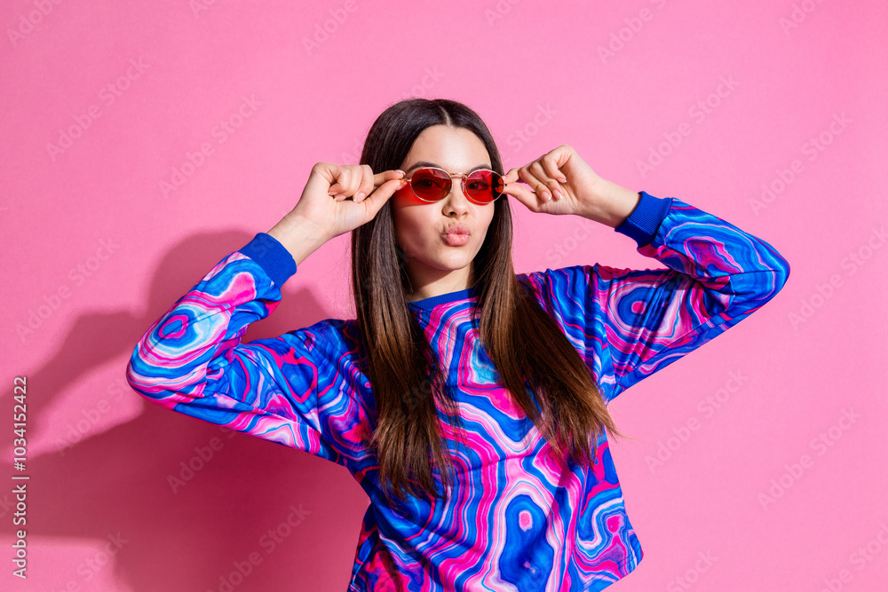 Photo portrait of attractive teen woman sunglass touch sunglass dressed stylish colorful clothes isolated on pink color background Photo portrait of attractive teen woman sunglass touch sunglass dressed stylish colorful clothes isolated on pink color background