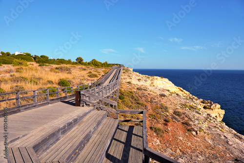 wooden walkway on algar seco amidst beautiful rock formations in Carvoeiro, Lagoa, Algarve, Portugal photo