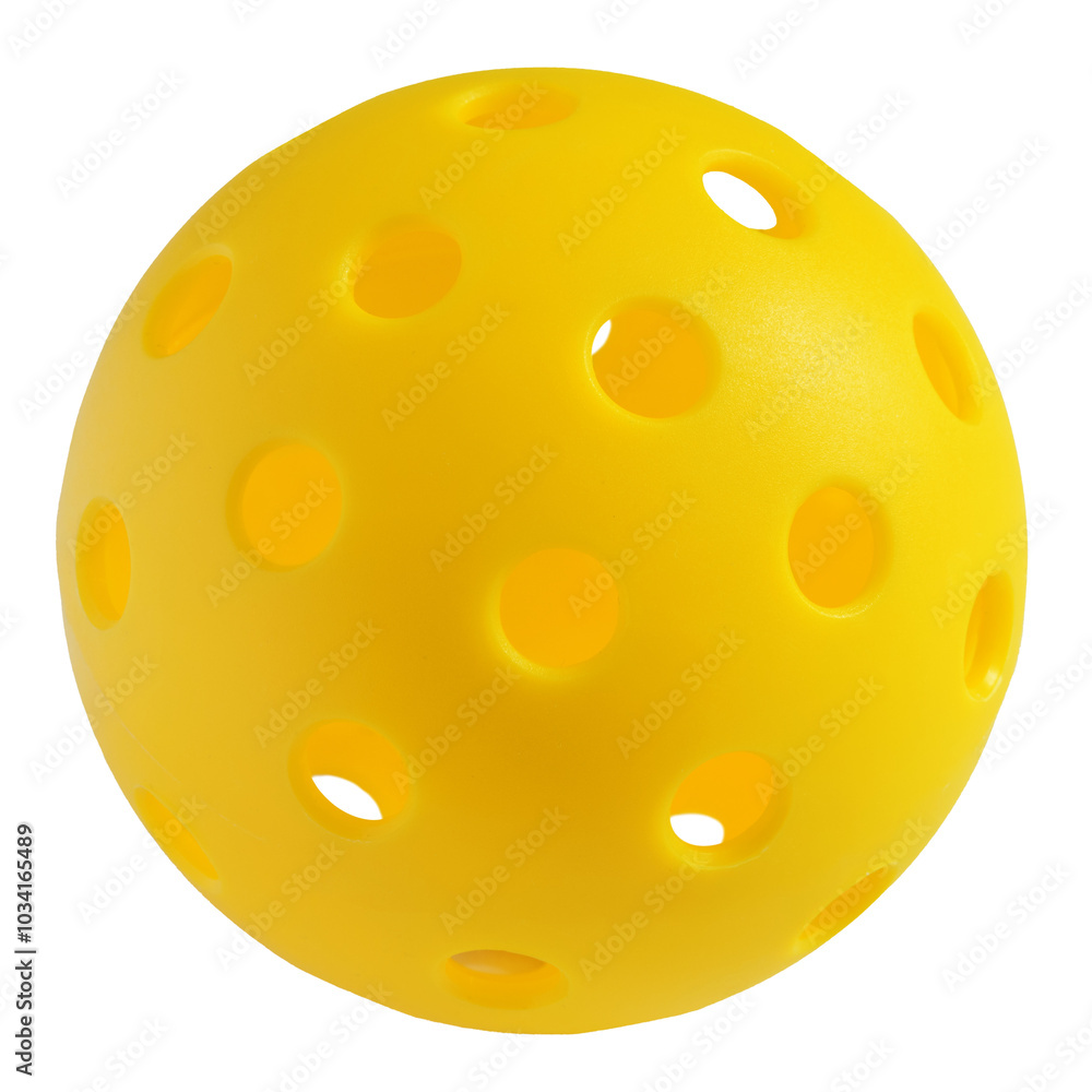 Fototapeta premium The pickleball ball is hard and perforated, bright yellow.