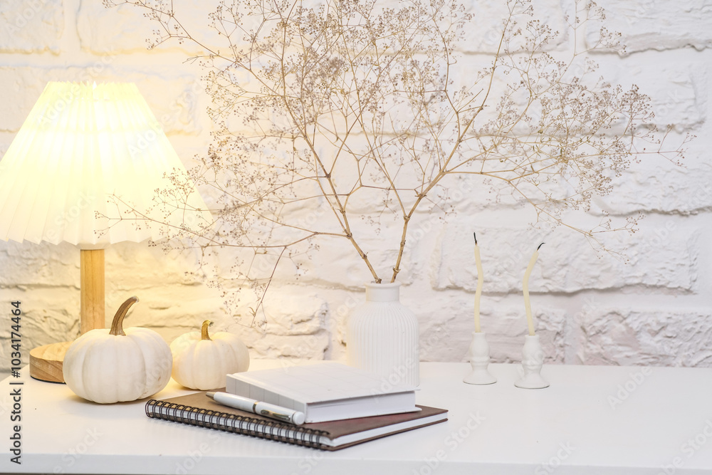 Fototapeta premium Create a Cozy Home Decor Atmosphere Using Notebooks and Natural Elements for Comfort.