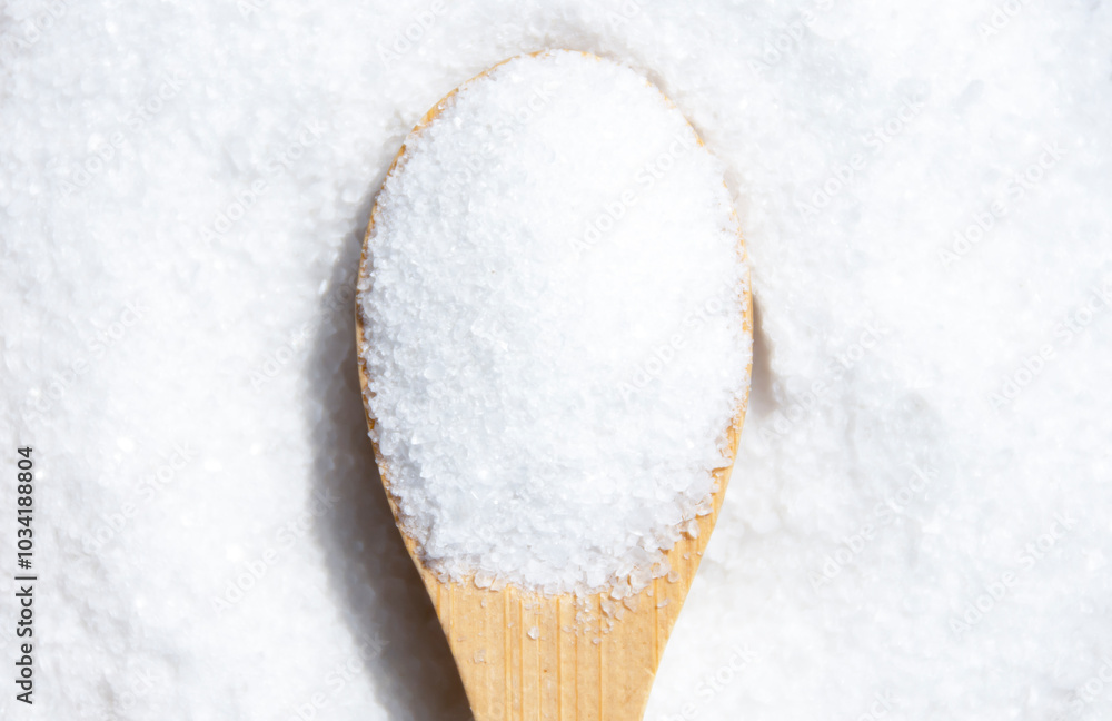 Salt in a wooden spoon close-up. Salt in a wooden spoon close-up.