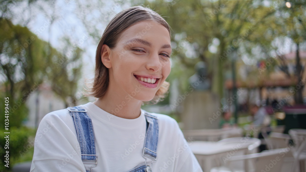 Smiling woman looking camera enjoying outdoors cafe closeup. Portrait happy girl Smiling woman looking camera enjoying outdoors cafe closeup. Portrait happy girl