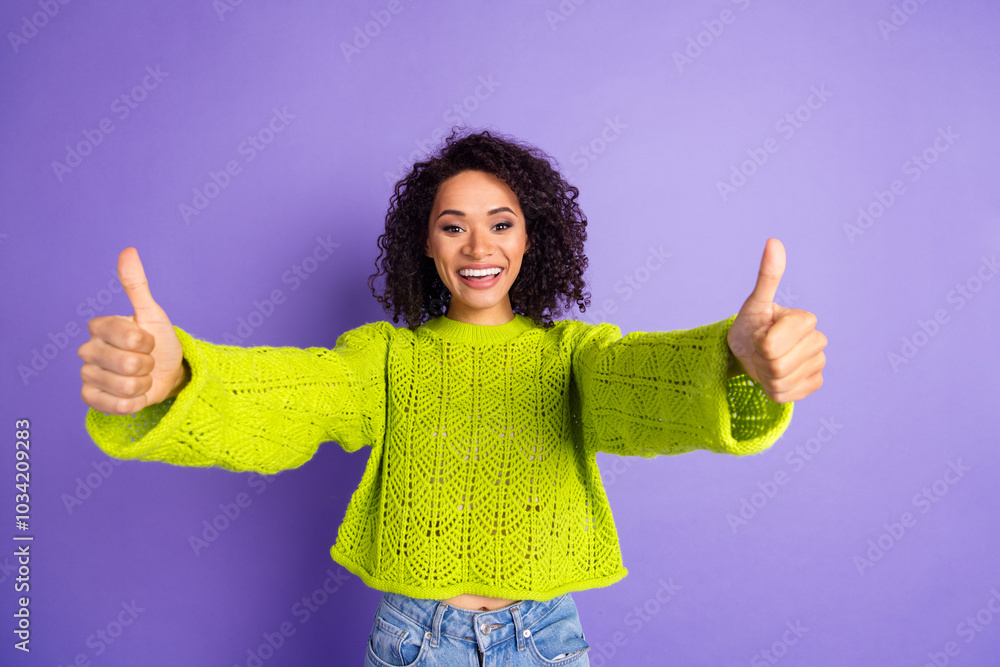 Portrait photo of wavy haired student girl in green trendy knitted sweater positive smile and like symbols isolated on violet color background Portrait photo of wavy haired student girl in green trendy knitted sweater positive smile and like symbols isolated on violet color background