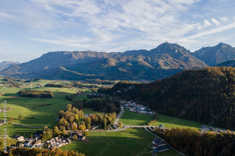Fototapeta premium Mountain valley with green fields and distant peaks 