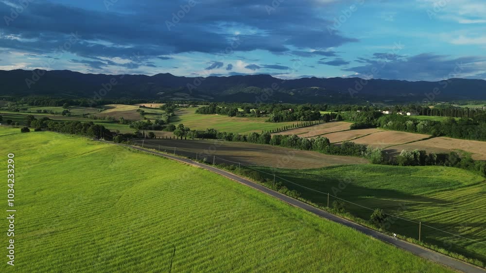 Classic Tuscany landscape with green hills and farmland country at sunrise. Aerial shot of green spring fields and hills in Tuscany, Italy Classic Tuscany landscape with green hills and farmland country at sunrise. Aerial shot of green spring fields and hills in Tuscany, Italy