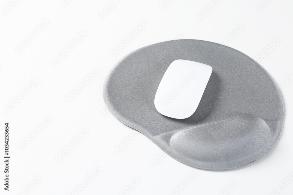 Mouse and mousepad with arm rest on white table, closeup. Space for text Mouse and mousepad with arm rest on white table, closeup. Space for text