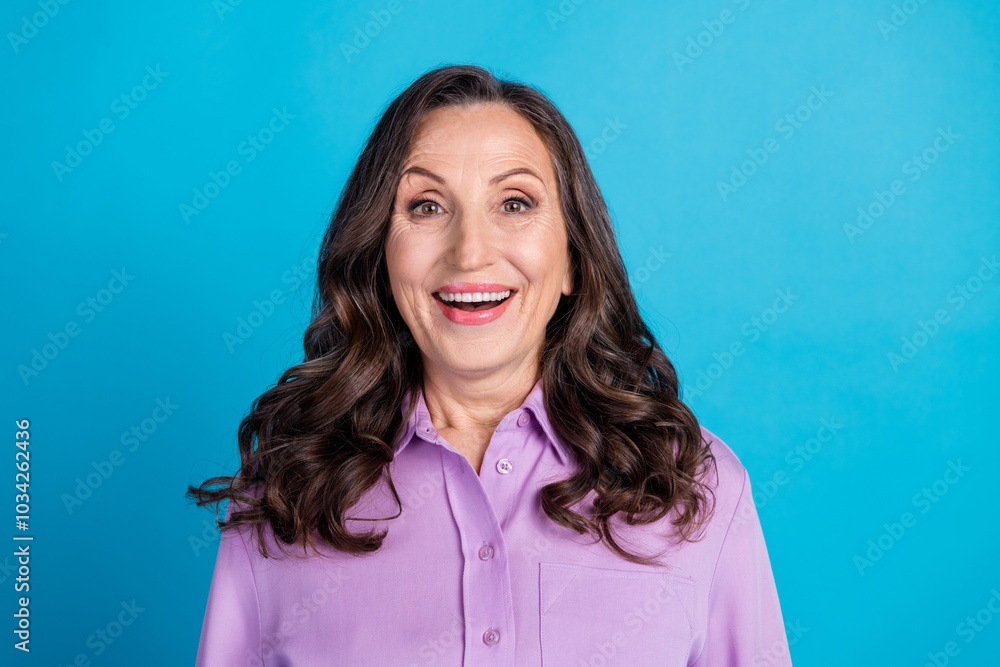 Fototapeta premium Photo of cheerful excited lady dressed puple blouse smiling empty space isolated blue color background