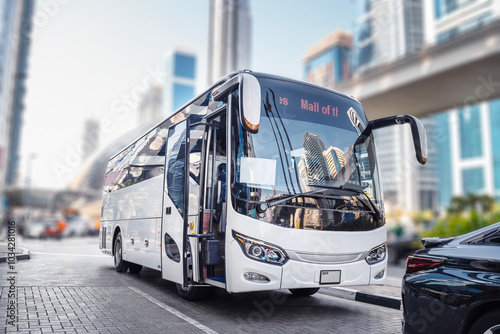 Photography Dubai, UAE. White tourist bus on a city street.