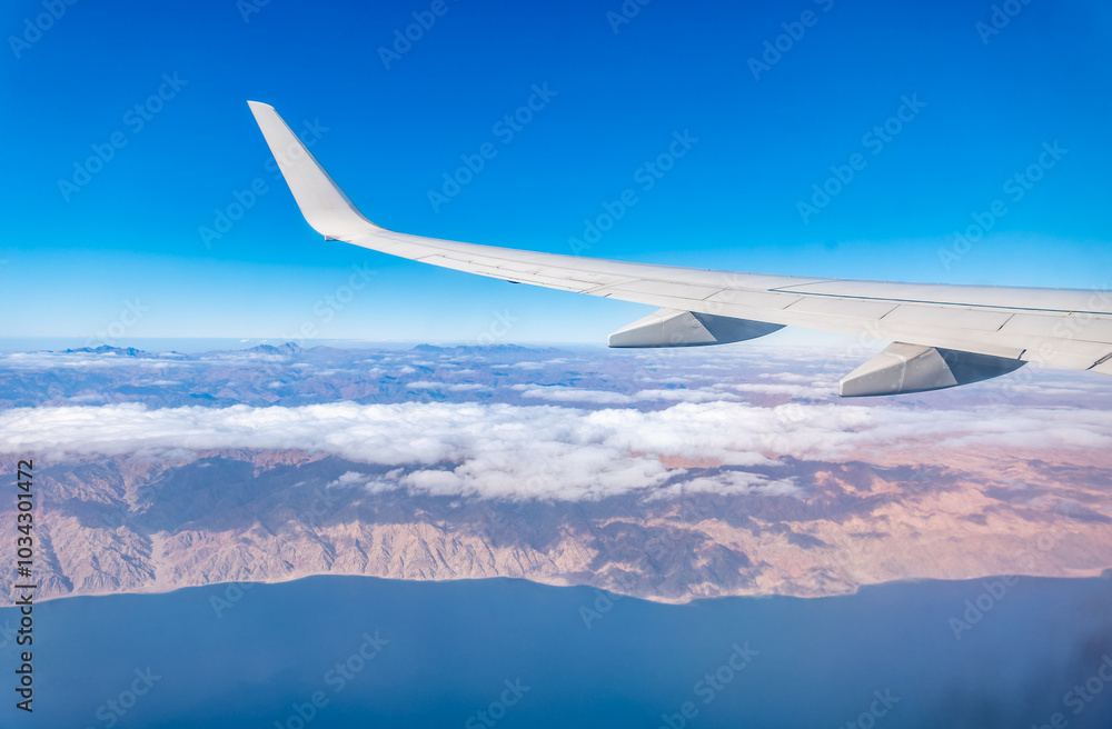 Obraz premium View from the airplane window of the mountains and sea resort with corals in Egypt, Sharm El Sheikh.Flight