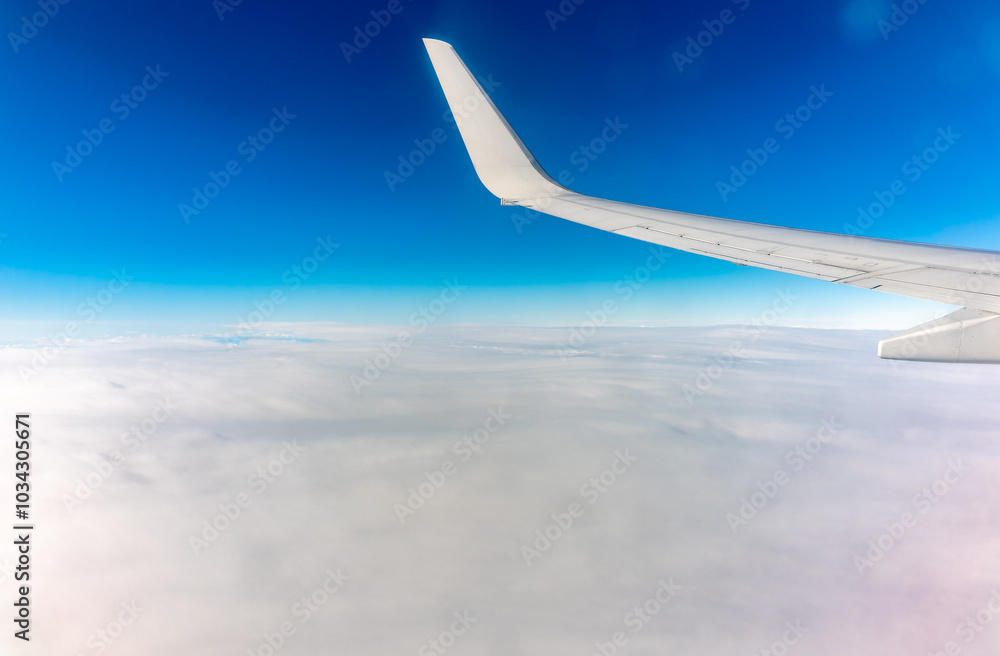View from the airplane window at a beautiful cloudy sky and the airplane wing View from the airplane window at a beautiful cloudy sky and the airplane wing