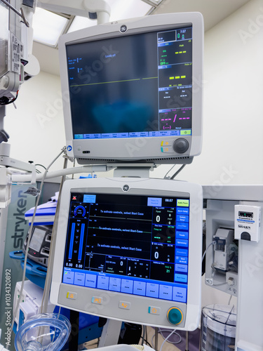 hospital monitors displaying vital signs, including heart rate, oxygen levels, and blood pressure. Represents the precision and urgency of medical care, life monitoring, and patient well-being