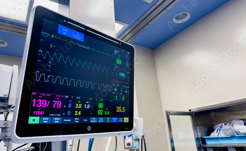 hospital monitors displaying vital signs, including heart rate, oxygen levels, and blood pressure. Represents the precision and urgency of medical care, life monitoring, and patient well-being