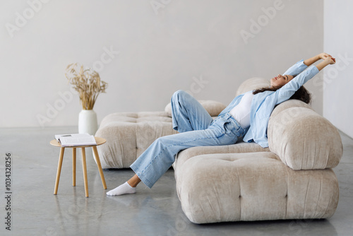 Obraz na plátně Calm satisfied woman stretching on couch thinking of pleasant lazy day, dreaming