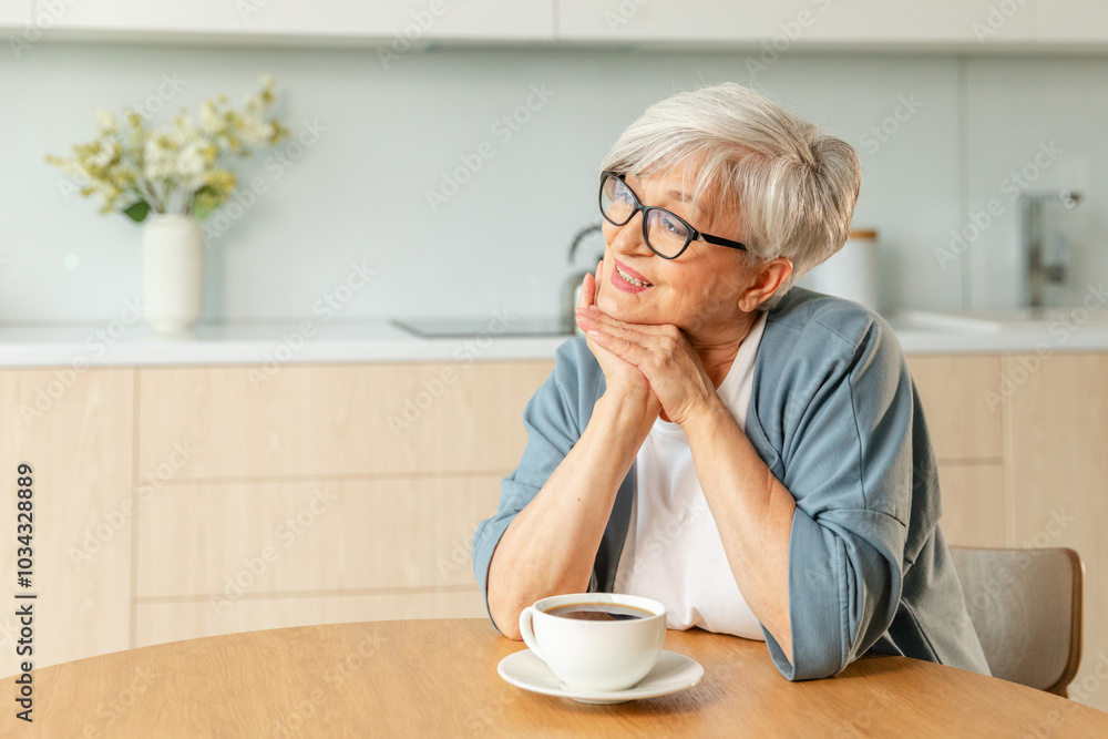 Good morning. Comfort relaxed senior old elderly woman grandmother drinking hot beverage tea coffee in kitchen at home. Mature woman resting enjoy calm morning at modern home alone. Pension concept Good morning. Comfort relaxed senior old elderly woman grandmother drinking hot beverage tea coffee in kitchen at home. Mature woman resting enjoy calm morning at modern home alone. Pension concept