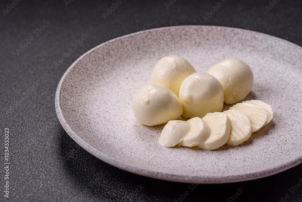 Delicious fresh mozzarella cheese with tomatoes, salt and spices Delicious fresh mozzarella cheese with tomatoes, salt and spices