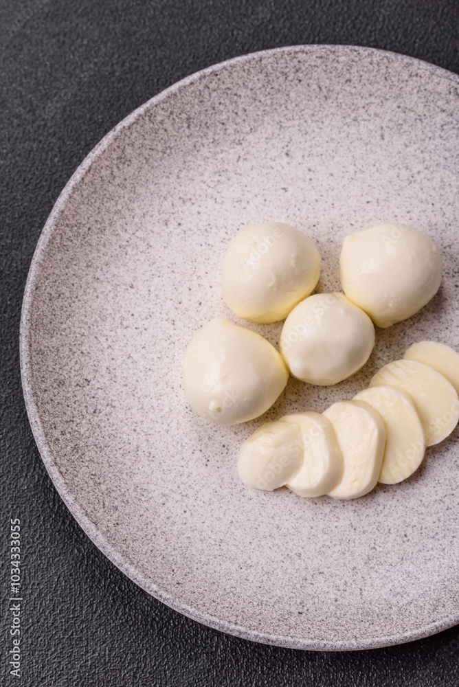 Delicious fresh mozzarella cheese with tomatoes, salt and spices Delicious fresh mozzarella cheese with tomatoes, salt and spices