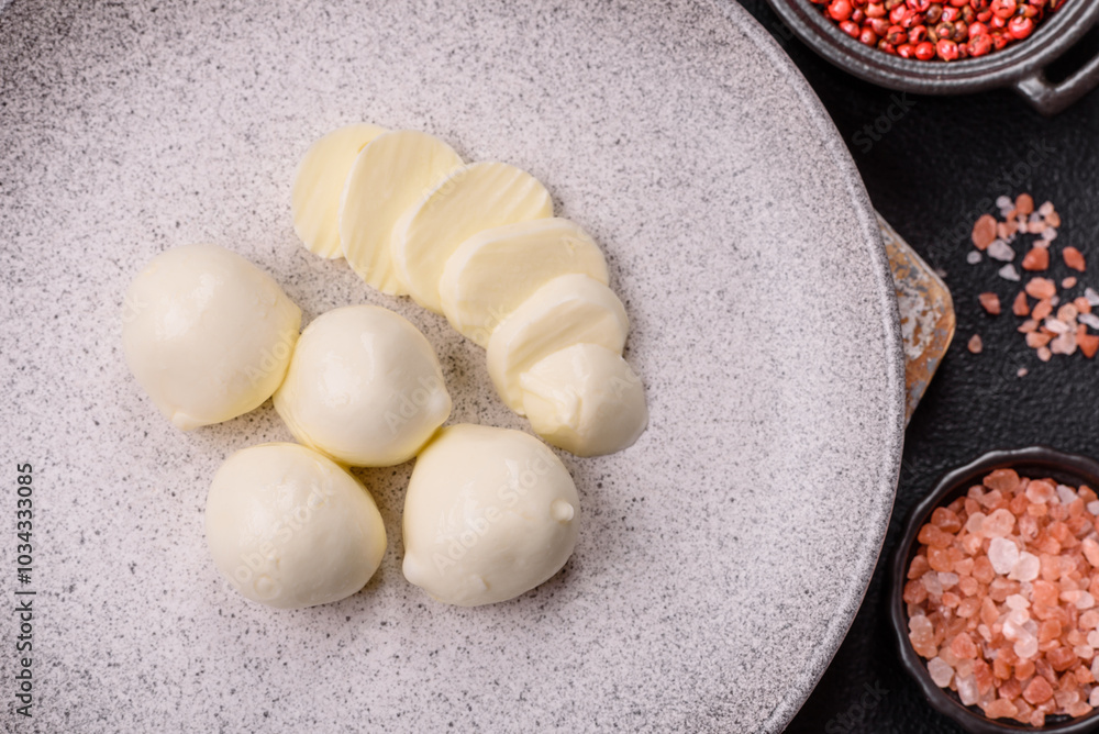Delicious fresh mozzarella cheese with tomatoes, salt and spices Delicious fresh mozzarella cheese with tomatoes, salt and spices